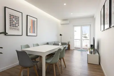 a dining room with a white table and chairs at Garret - Faro Apartment by HD in Faro
