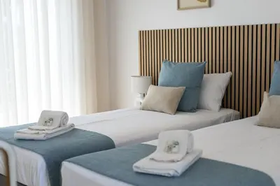 two beds with towels on top of them in a room at Villa da Ria - by HD Properties in Monte Negro