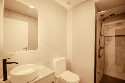 a white bathroom with a toilet and a shower at FLH Albufeira Boho Chic with Balcony in Albufeira