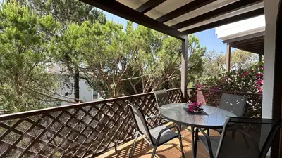 a table and chairs on a balcony with trees at Sun by Check-in Portugal in Albufeira