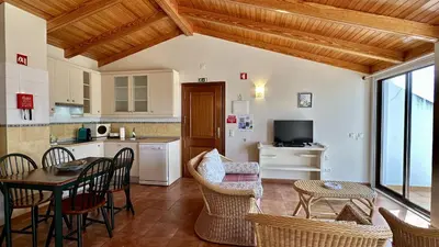 a kitchen and living room with a table and chairs at Sun by Check-in Portugal in Albufeira