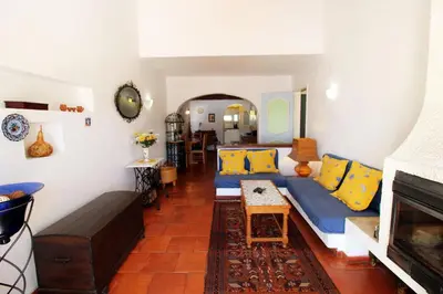 a living room with a blue couch and yellow pillows at V2 - Aldeia do Golfe B2 in Quarteira
