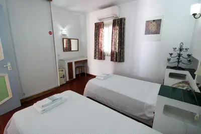 two beds in a room with white walls at V2 - Aldeia do Golfe B2 in Quarteira