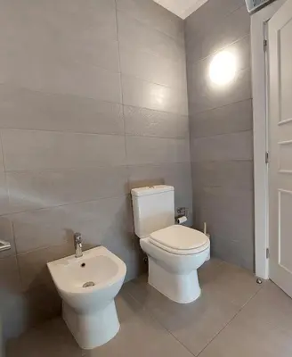 a bathroom with a toilet and a sink at Vilamouratenis Duck by SAPvillas in Vilamoura