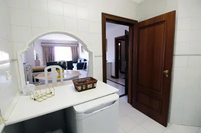 a kitchen with a sink and a mirror in a room at Al-Charb Retreat by SAPvillas in Quarteira