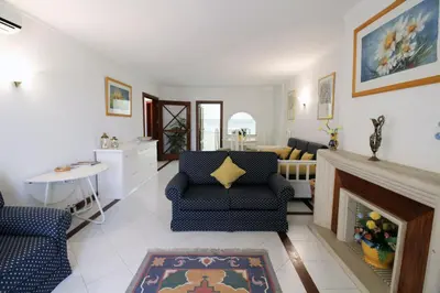 a living room with two chairs and a fireplace at Al-Charb Retreat by SAPvillas in Quarteira
