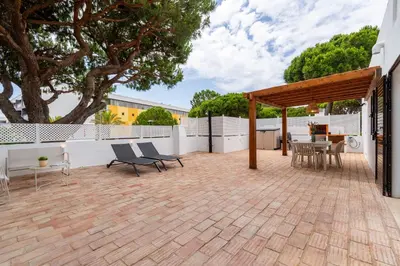 a patio with a table and chairs and a pavilion at Terra Alba in Olhos de Água