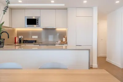 a kitchen with white cabinets and a counter top at Terra Alba in Olhos de Água