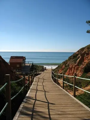 a wooden pathway leading to the beach at T1 in Albufeira near Alfamar Hotel in Albufeira