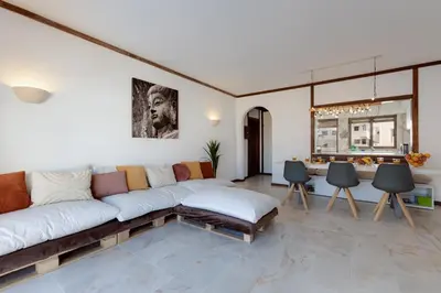 a living room with a couch and a table at Beachtime - Oura Beach Apartment in Albufeira