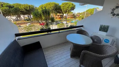 a balcony with a table and chairs on a balcony at Tenis, Golf e Mar in Quarteira