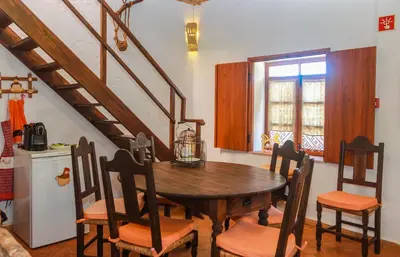 a dining room with a wooden table and chairs at Casa da Tita in Salir