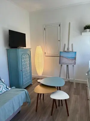 a bedroom with a bed and a table and a tv at Delta Marina Vilamoura in Quarteira