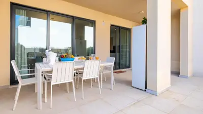 a dining room with a table and chairs at Terrazza Beach & Golf in Quarteira