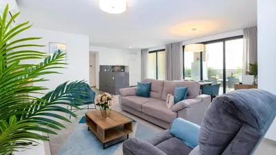 a living room with a couch and a table at Terrazza Beach & Golf in Quarteira