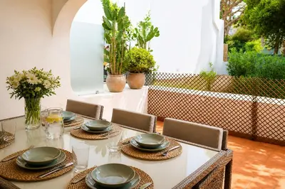 a room with a table and chairs and a window at Bloom Place VALE DO LOBO - Apartamento acolhedor com terraço in Vale do Lobo