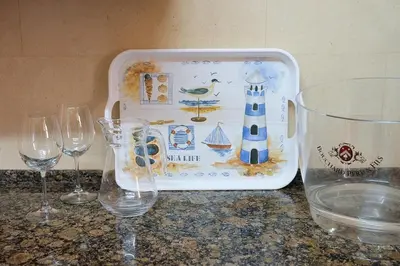 a plastic container with wine glasses on a counter at Bloom Place VALE DO LOBO - Apartamento acolhedor com terraço in Vale do Lobo