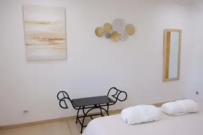 a room with two beds and a chair in it at Bloom Place VALE DO LOBO - Apartamento acolhedor com terraço in Vale do Lobo