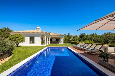 a villa with a swimming pool and a house at Villa Zambujal in Boliqueime