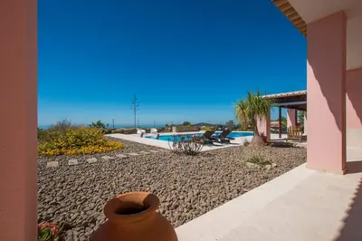 a house with a yard with a swimming pool at Villa Mujeira in Loulé