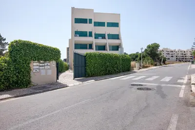an empty street in front of a building at Salgados Beach House in Albufeira