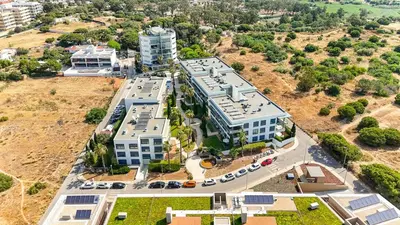 an aerial view of a building in a city at Beach 1Min! & Pool - Private Parking, AC & WiFi in Quarteira