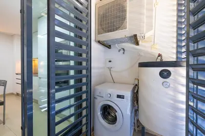 a laundry room with a washer and dryer at Beach 1Min! & Pool - Private Parking, AC & WiFi in Quarteira