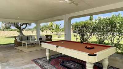 a pool table on a screened in porch at Laranjal by Check-in Portugal in Quarteira