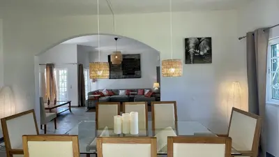 a dining room and living room with a glass table at Laranjal by Check-in Portugal in Quarteira