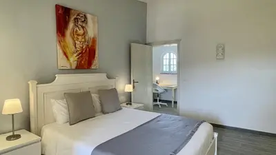 a bedroom with a bed and a painting on the wall at Laranjal by Check-in Portugal in Quarteira