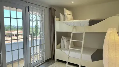 a bedroom with bunk beds and a balcony at Laranjal by Check-in Portugal in Quarteira