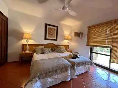 a bedroom with a bed and two lamps and a window at Amazing T3 -Clube Albufeira in Albufeira