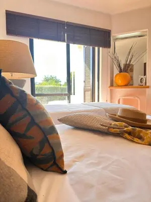 a bedroom with a bed with pillows and a window at Amazing T3 -Clube Albufeira in Albufeira