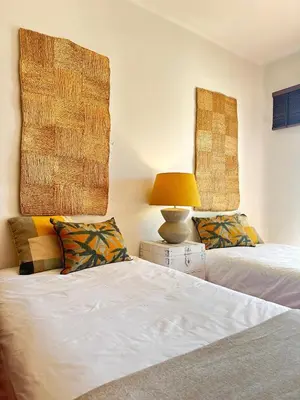 a bedroom with two beds and a lamp on a night stand at Amazing T3 -Clube Albufeira in Albufeira