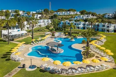 an aerial view of a resort swimming pool with umbrellas at Amazing T3 -Clube Albufeira in Albufeira