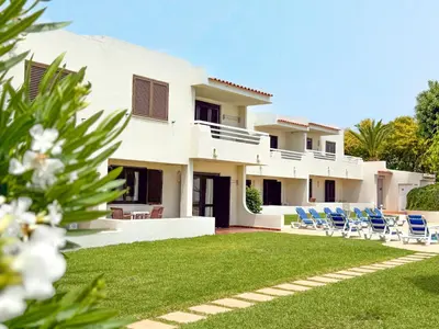 a view of a house with chairs and a yard at Aura Village - City Beach Apartments in Albufeira