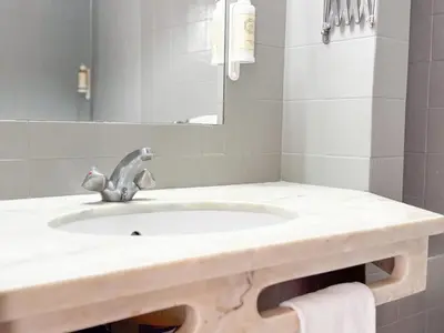 a bathroom with a sink and a mirror at Aura Village - City Beach Apartments in Albufeira