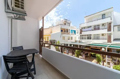 a balcony with a table and a view of a building at Downtown Apartment - BE by HelloVacations in Albufeira