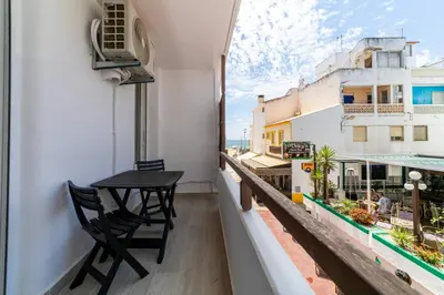 a balcony with a table and chairs on a building at Downtown Apartment - BE by HelloVacations in Albufeira