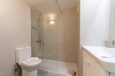 a bathroom with a shower and a toilet and a sink at Downtown Apartment - BE by HelloVacations in Albufeira