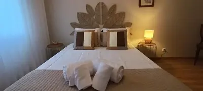 a bedroom with a bed with towels on it at Faro Station Eleven Guest House in Faro