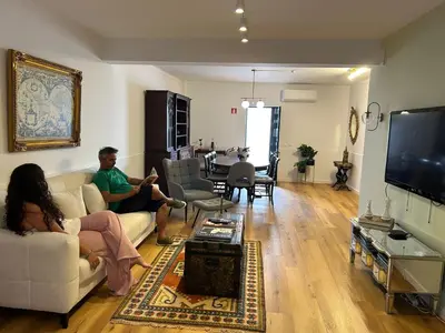 a man and a woman sitting in a living room at Faro Station Eleven Guest House in Faro