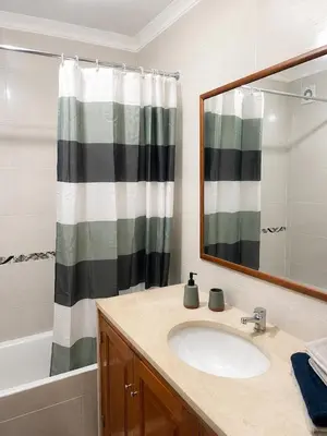 a bathroom with a sink and a mirror and a shower at Casa Sérénity By Calyferias in Guia