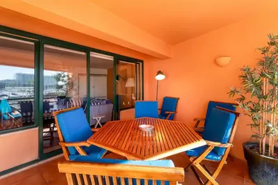 a dining room with a wooden table and chairs at Pearl Harbor 3 BDR Flat VLM Marina by LovelyStay in Quarteira