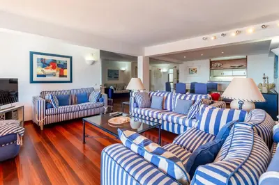 a living room with blue and white striped couches at Pearl Harbor 3 BDR Flat VLM Marina by LovelyStay in Quarteira