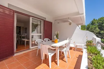 a patio with a white table and chairs at Pool Apartment Vilamoura near Old Village in Quarteira