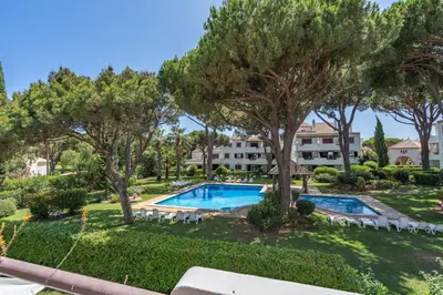 an image of a swimming pool in a yard with trees at Pool Apartment Vilamoura near Old Village in Quarteira