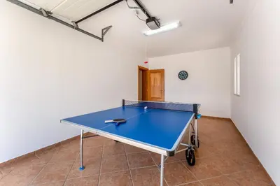 a ping pong table in the middle of a room at Villa Castelo by Algarve Holidays in Albufeira