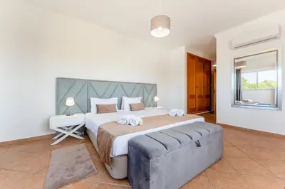 a large bedroom with a large bed and a couch at Villa Castelo by Algarve Holidays in Albufeira