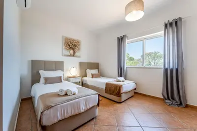 a bedroom with two beds and a window at Villa Castelo by Algarve Holidays in Albufeira